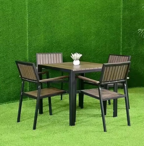 Simple Table Set Furniture Outdoor Patio Dining Set By Metal Frame with four wooden chairs on green grass.