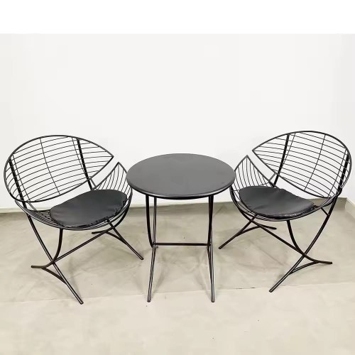 Nordic style furniture chairs with cushions and a round table.