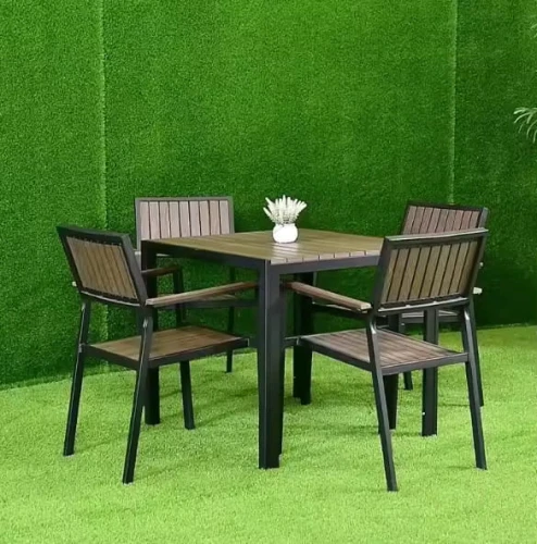 Simple Table Set Furniture Outdoor Patio Dining Set By Metal Frame with four wooden chairs on green grass.
