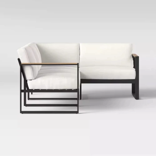 Modern black metal patio sofa set with white cushions.