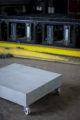 Modern Coffee table on wheels in industrial setting.