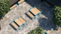 Nørrebro Outdoor Table 180 cm 6-8 Seats with wooden top and blue steel frame on a paved courtyard.