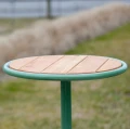 Nordhavn Outdoor Stool | 30 cm with wooden seat and green frame in a garden setting.