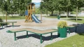 Nordhavn Outdoor Planter 55 l next to park benches and playground equipment in a park.