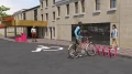Ørestad Bike Stand installed in front of a building, securing a bicycle.