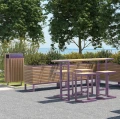 Amager Outdoor Bar Table set in a garden with trees in the background.
