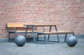 Amager Outdoor Table 150 cm 4-6 Seats with benches against a brick wall
