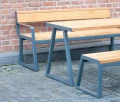 Amager Outdoor Table 180 cm 6-8 Seats with matching benches on a paved patio.
