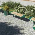 Nordhavn 3 Seater Public Backless Bench in a garden setting with gravel and shrubs.