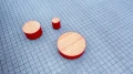Valby Public Backless Bench | Round on a tiled surface.