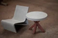 Concrete chair and coffee table with concrete top and wooden legs.