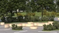 Valby Public Backless Bench | Quarter Round in a park setting with greenery and trees.