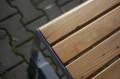 Frederiksberg 3 Seater Public Backrest Bench wooden seat and metal frame close-up.