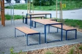 Frederiksberg Outdoor Table 150 cm 4-6 Seats with matching benches in a park setting.