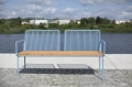 Østerbro 3 Seater Public Backrest Bench w/ Armrest placed on a waterfront deck.