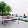 Østerbro 3 Seater Public Backless Bench in a modern outdoor seating area by the sea.