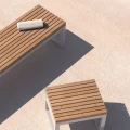 Hellerup 3 Seater Public Backless Bench with wooden slats on concrete surface.