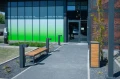 Wooden Hellerup Street Litter Bin in front of modern building.