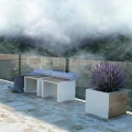 Indre By Outdoor Planter | 85 l planter with purple flowers on a modern balcony.