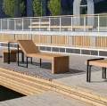 Vesterbro Lounge Bench w/ Small Table | Oak displayed on outdoor wooden deck.
