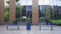 Blue Sydhavn Outdoor Planter with shrub on modern patio.