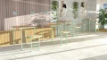 Holmen Outdoor Bar Table 4 Seats in a modern open space with green accents.