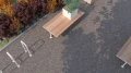 Holmen Bike Stand | U Shape next to a wooden outdoor table with planters.