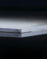 Edge of HPL PLATE SILVER thickness 6 mm (SAMPLE 50×50 MM).