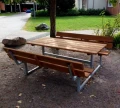 Outdoor Bench &amp; table (galvanized steel) in a garden setting.