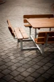 Square Bench &amp; Table set on a cobblestone pavement
