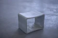 Concrete table on a grey concrete floor.