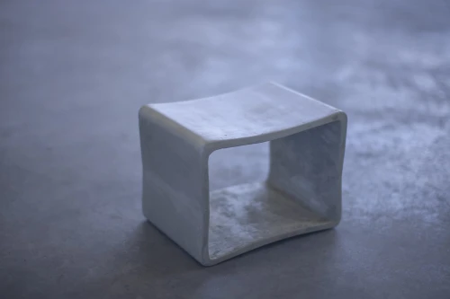 Concrete table on a grey concrete floor.