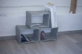 Concrete table used as a bookshelf for magazines.