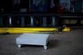 Coffee table with industrial design on wheels in a factory setting.